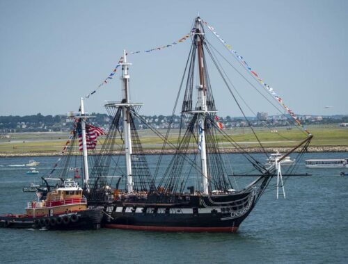 USS Constitution (Old Ironsides) sailing in Boston Harbor with full sails – preserved through Navy's Constitution Grove in Indiana"