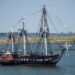 USS Constitution (Old Ironsides) sailing in Boston Harbor with full sails – preserved through Navy's Constitution Grove in Indiana"