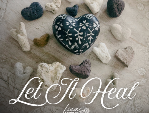 dark floral heart stone surrounded by heart-shaped coral and volcanic stones on light patterned wood for Let It Heal cover art
