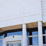 The Arizona State Courts Building in Phoenix, home of the Arizona Supreme Court, with the words "Where law ends, tyranny begins" carved above its entrance.