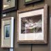 How to hang pictures: framed photographs and prints hung in a tidy group on a gallery wall at Framers Market & Gallery.